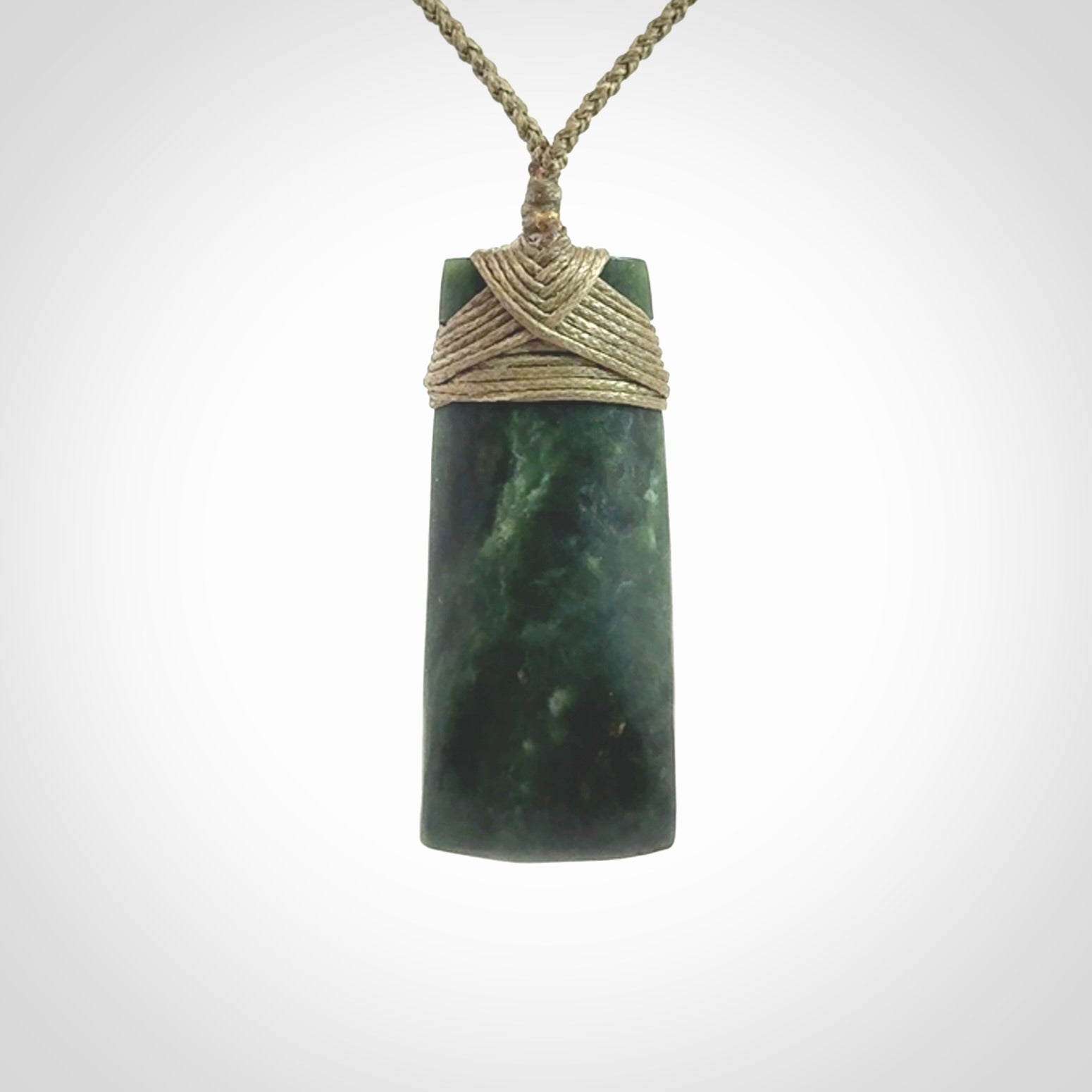Hand carved Toki pendant from a lovely piece of local New Zealand Jade. We have suspended this from a 4-plait olive cord which can be adjusted with a couple of slip knots and olive binding.