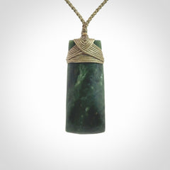 Hand carved Toki pendant from a lovely piece of local New Zealand Jade. We have suspended this from a 4-plait olive cord which can be adjusted with a couple of slip knots and olive binding.