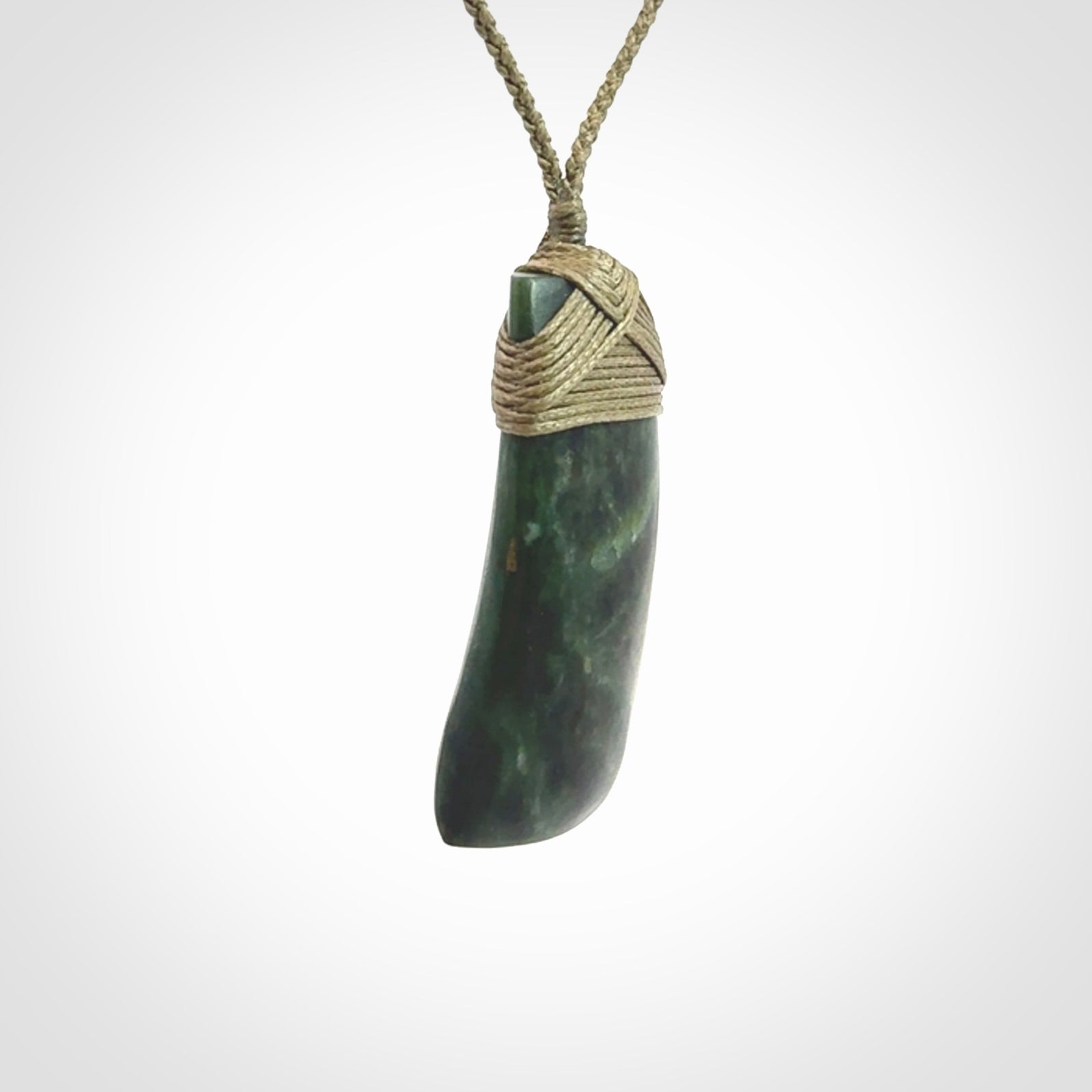 Hand carved Toki pendant from a lovely piece of local New Zealand Jade. We have suspended this from a 4-plait olive cord which can be adjusted with a couple of slip knots and olive binding.