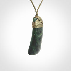 Hand carved Toki pendant from a lovely piece of local New Zealand Jade. We have suspended this from a 4-plait olive cord which can be adjusted with a couple of slip knots and olive binding.