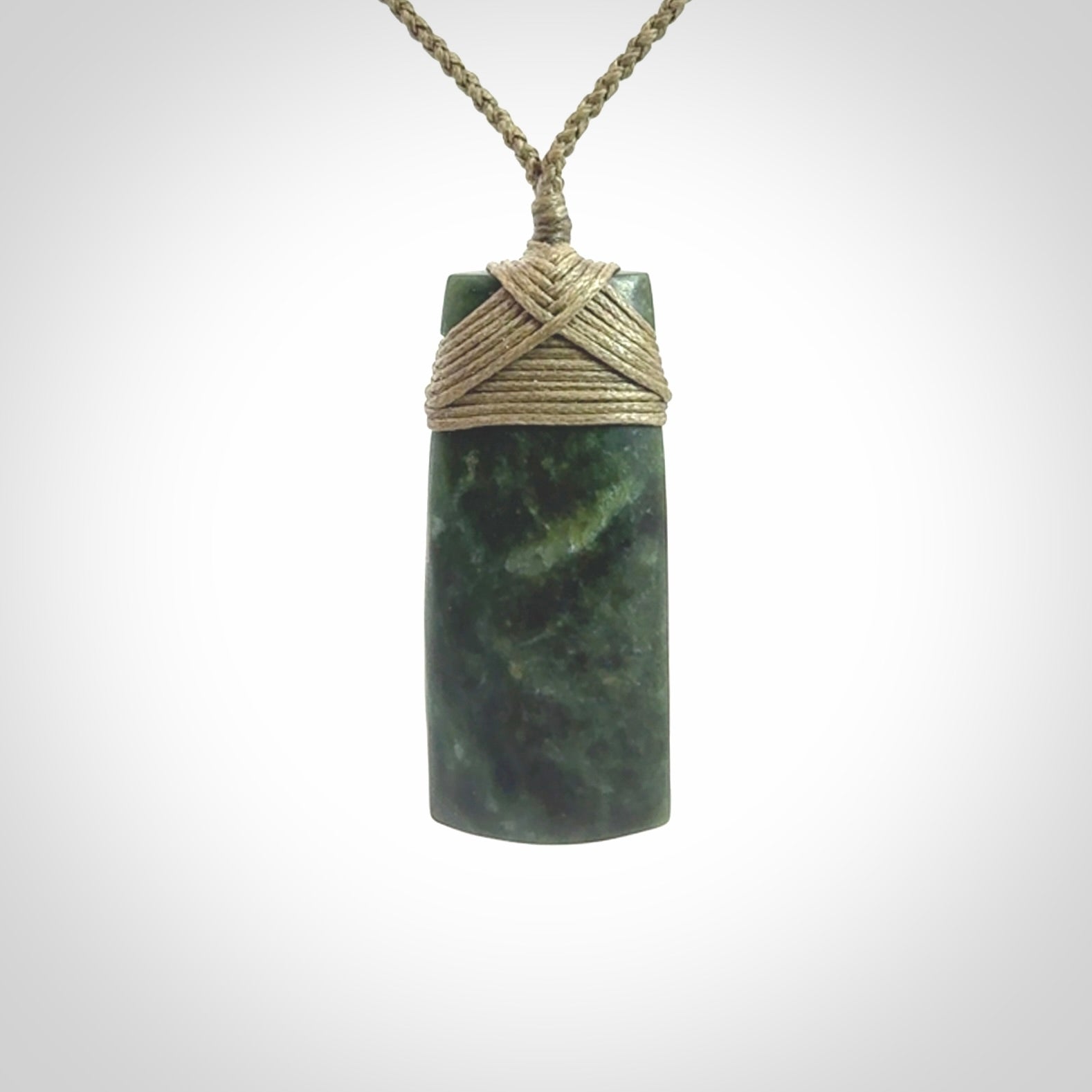 Hand carved Toki pendant from a lovely piece of local New Zealand Jade. We have suspended this from a 4-plait olive cord which can be adjusted with a couple of slip knots and olive binding.