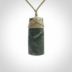 Hand carved Toki pendant from a lovely piece of local New Zealand Jade. We have suspended this from a 4-plait olive cord which can be adjusted with a couple of slip knots and olive binding.
