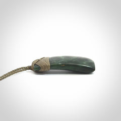 Hand carved Toki pendant from a lovely piece of local New Zealand Jade. We have suspended this from a 4-plait olive cord which can be adjusted with a couple of slip knots and olive binding.