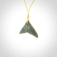 Hand carved New Zealand Marsden Jade whale tail pendant.