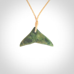Hand carved New Zealand Marsden Jade whale tail pendant.