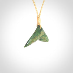 Hand carved New Zealand Marsden Jade whale tail pendant.