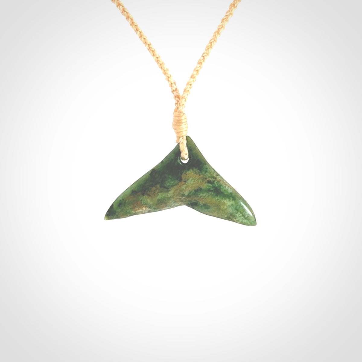 Hand carved New Zealand Marsden Jade whale tail pendant.