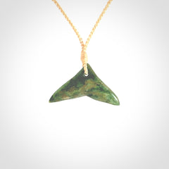 Hand carved New Zealand Marsden Jade whale tail pendant.