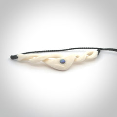 A hand carved twist pendant made from bone. This is a work of art carved by Fumio Noguchi who is renowned for his skill in bone carving. We deliver this pendant to you on a plaited black cord. Delivery with Express Courier is included in the price.