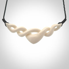 A hand carved twist pendant made from bone. This is a work of art carved by Fumio Noguchi who is renowned for his skill in bone carving. We deliver this pendant to you on a plaited black cord. Delivery with Express Courier is included in the price.