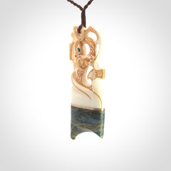 This is a large carved Manaia pendant. It is made from unique materials - New Zealand Obay Stone, Bone, Paua shell, Brass. The face of the Manaia is carved with a traditional design in the front. It is carved front and back and has traditional carved designs. This is a large and very traditional pendant that is a collectors piece.