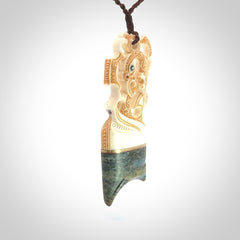 This is a large carved Manaia pendant. It is made from unique materials - New Zealand Obay Stone, Bone, Paua shell, Brass. The face of the Manaia is carved with a traditional design in the front. It is carved front and back and has traditional carved designs. This is a large and very traditional pendant that is a collectors piece.