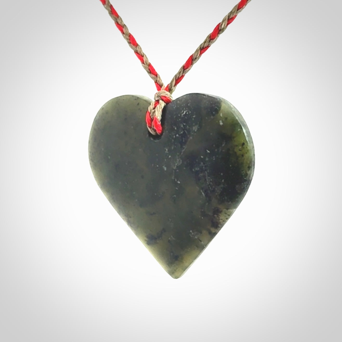 A hand carved heart pendant made from New Zealand jade.