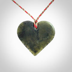 A hand carved heart pendant made from New Zealand jade.