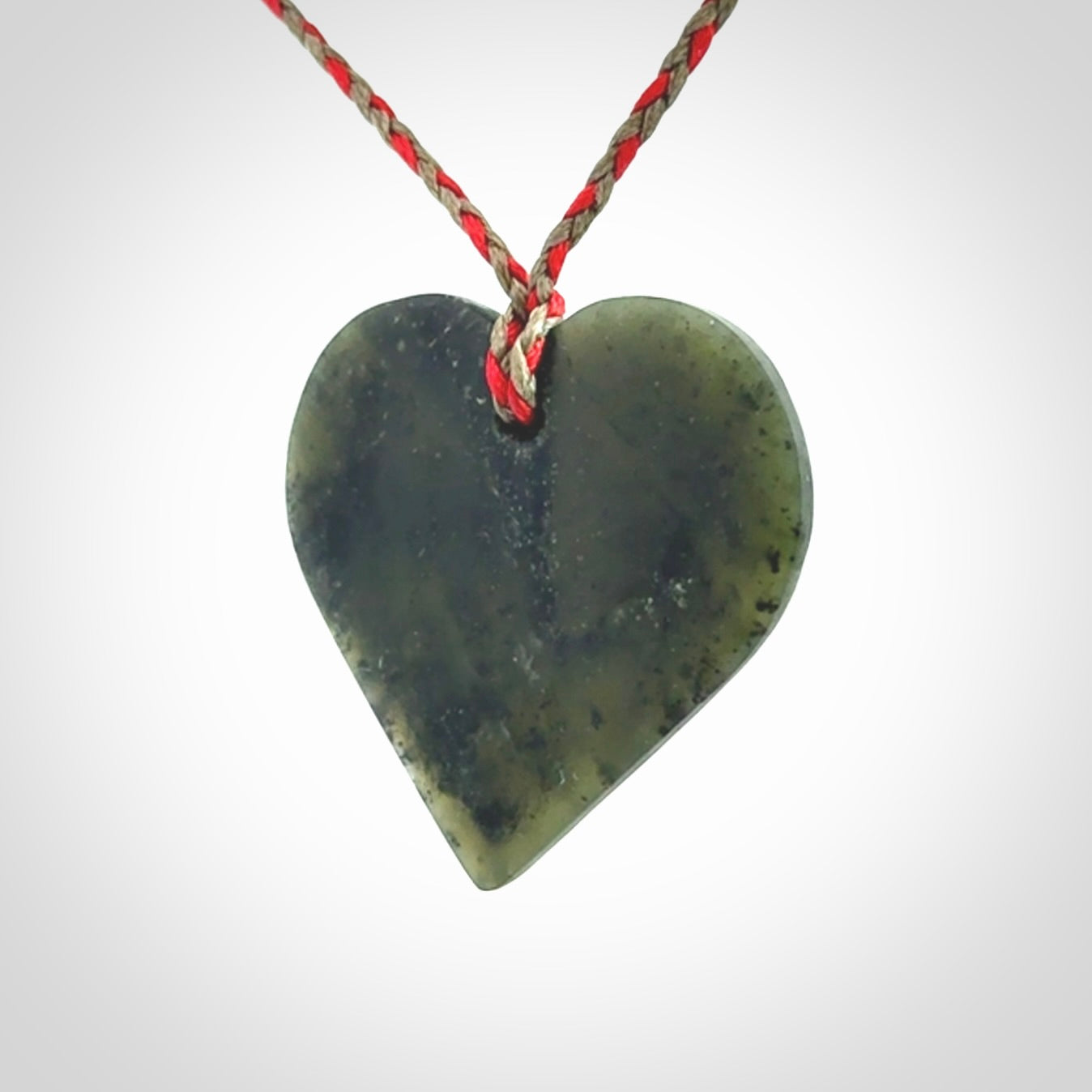 A hand carved heart pendant made from New Zealand jade.