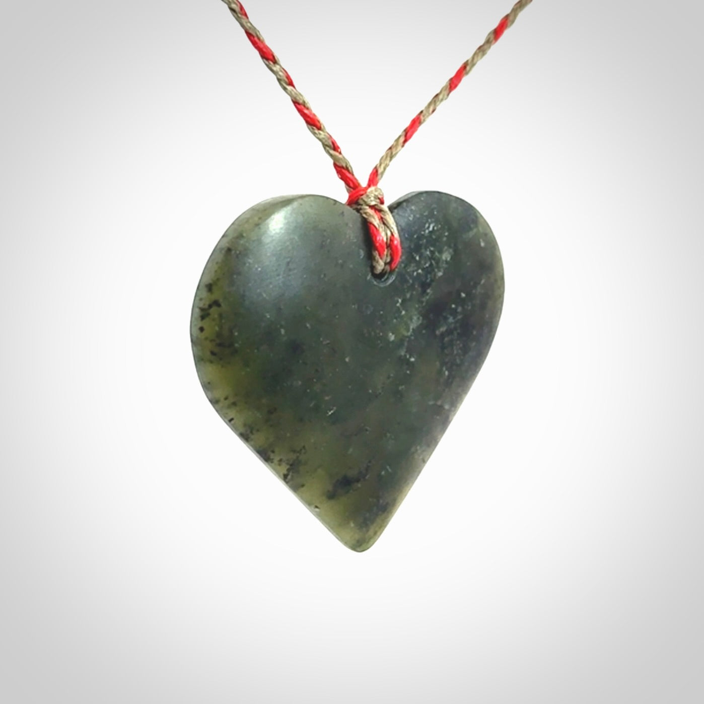 A hand carved heart pendant made from New Zealand jade.