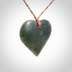 A hand carved heart pendant made from New Zealand jade.