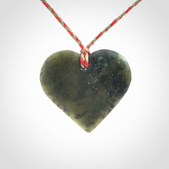 A hand carved heart pendant made from New Zealand jade.