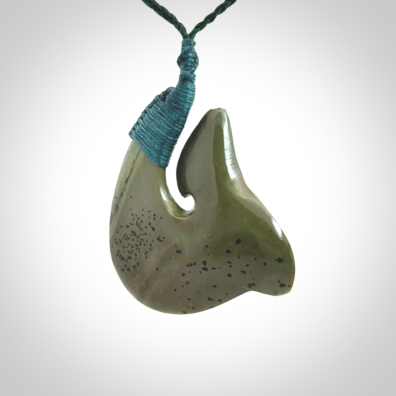 Hand carved New Zealand Kokopu jade hook, matau pendant.