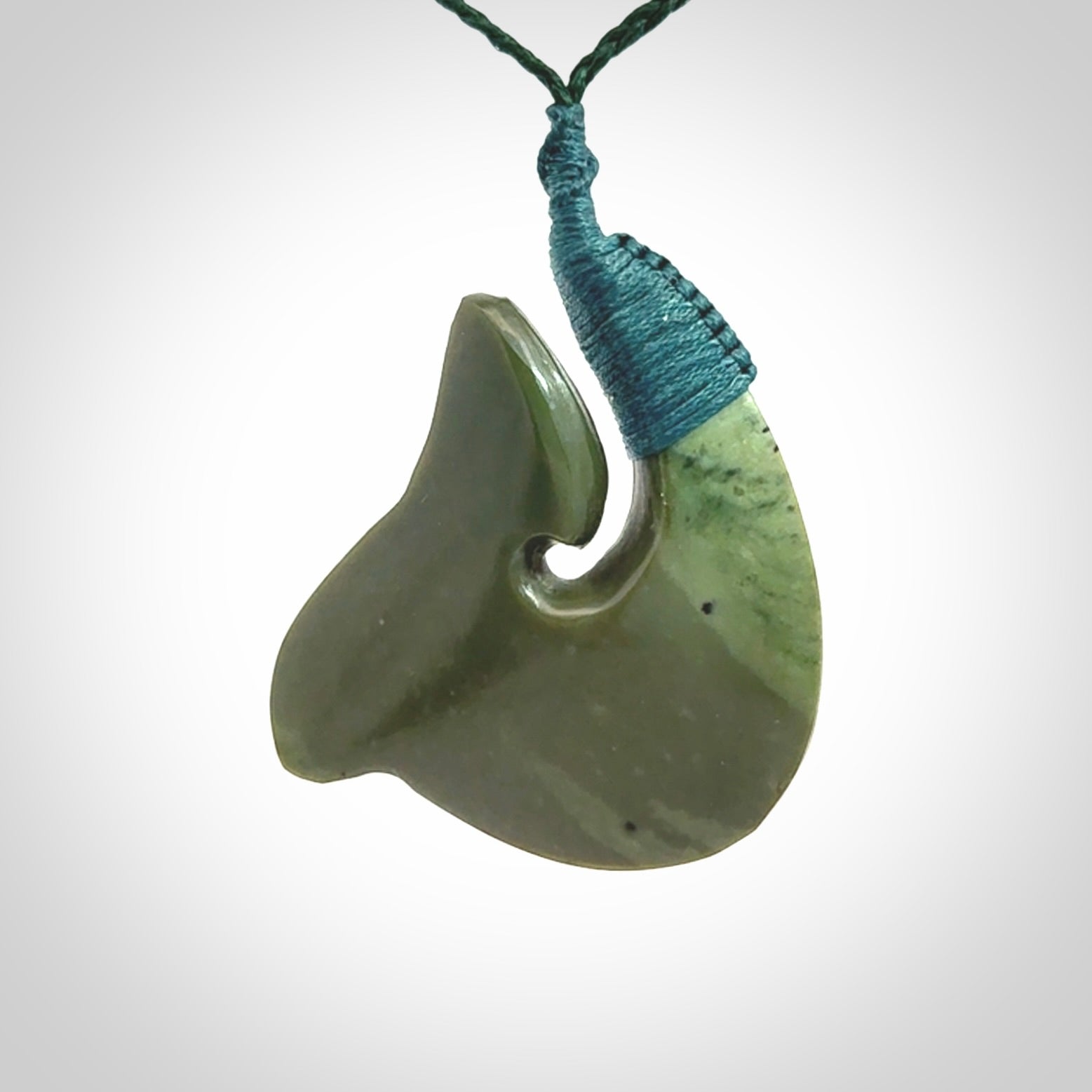 Hand carved New Zealand Kokopu jade hook, matau pendant.