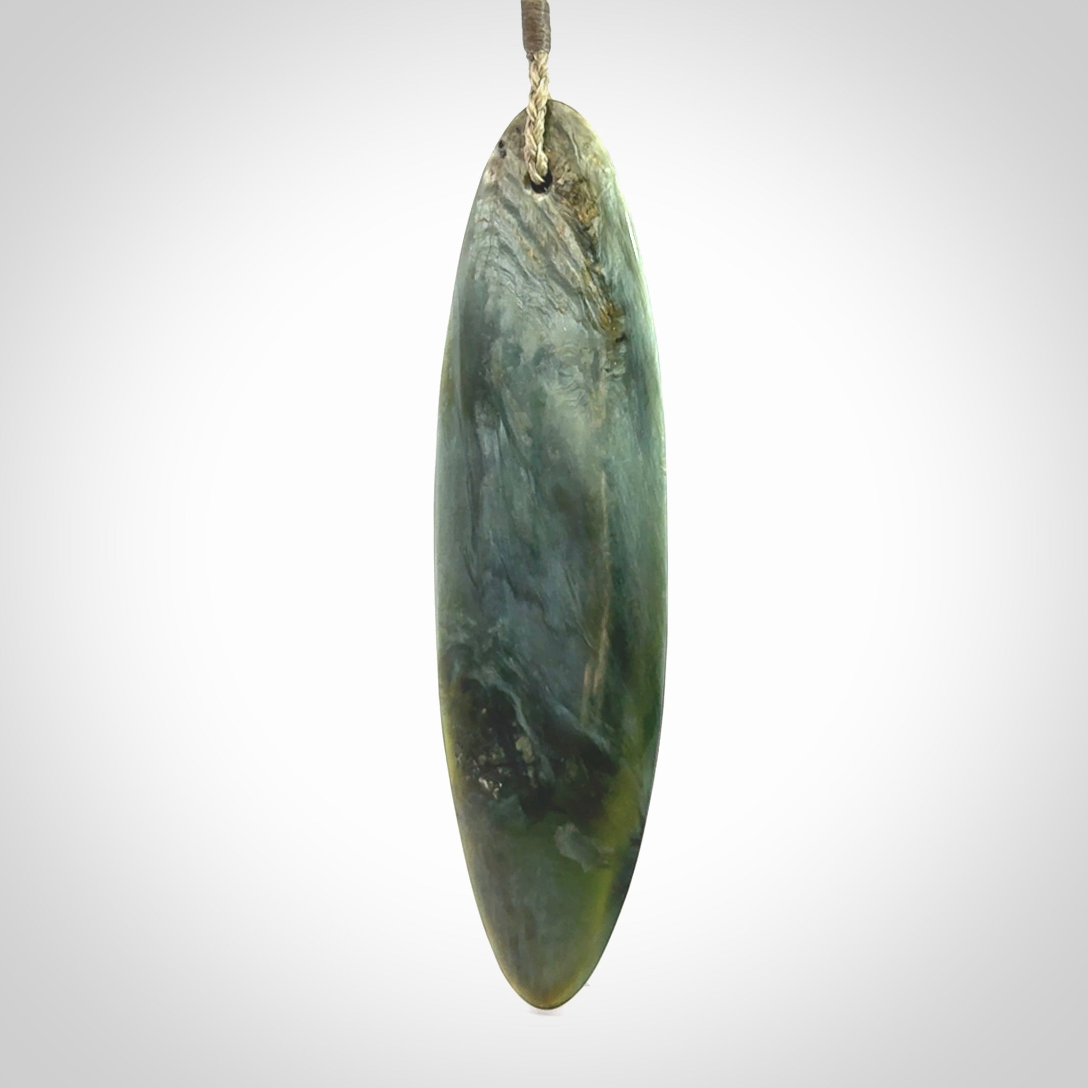 This picture shows a beautiful large sized drop pendant carved in New Zealand Tangiwai pounamu. It is a lovely chatoyant green/blue colour, which is semi-translucent when held to the light. A gorgeous and very meaningful pendant with an adjustable cord.