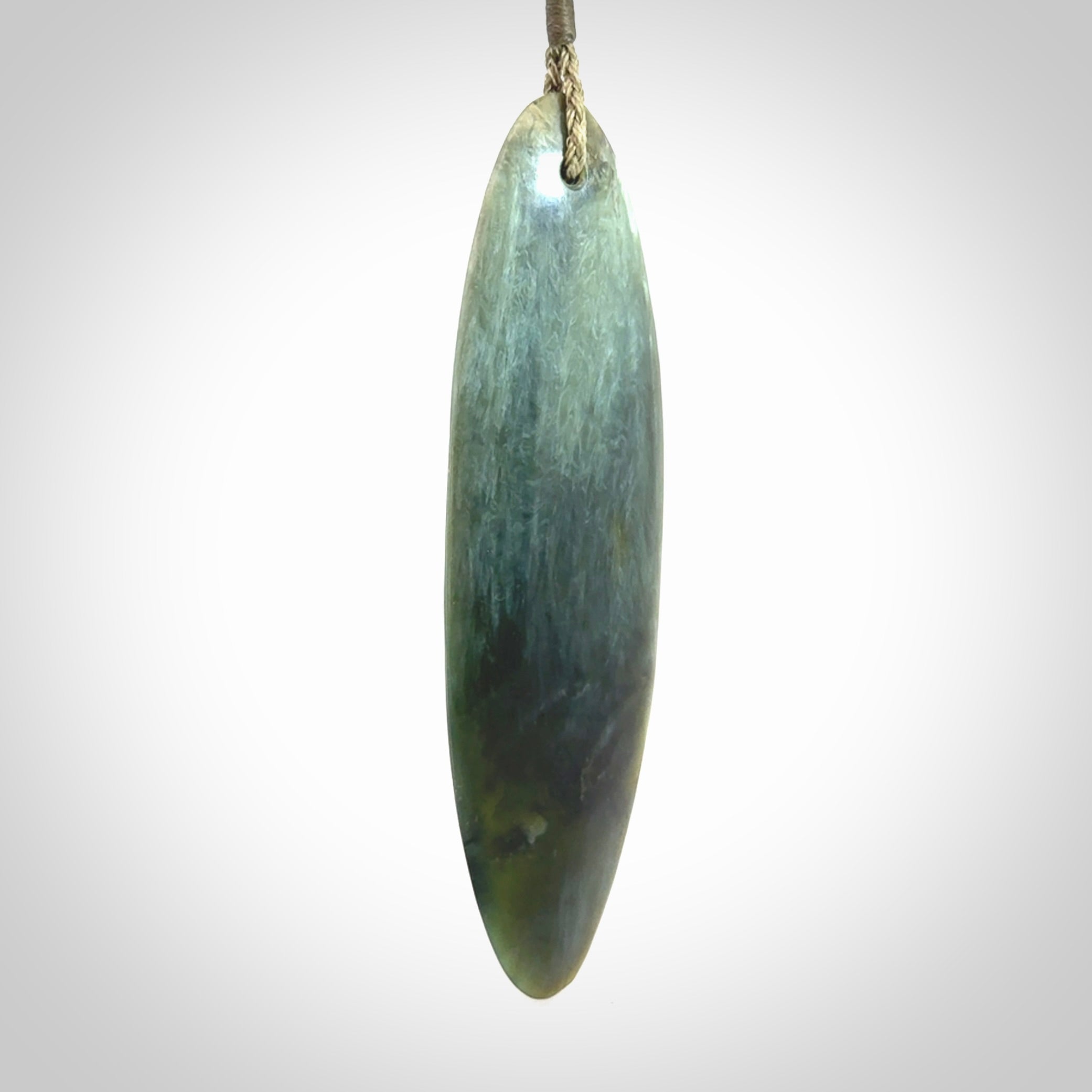 This picture shows a beautiful large sized drop pendant carved in New Zealand Tangiwai pounamu. It is a lovely chatoyant green/blue colour, which is semi-translucent when held to the light. A gorgeous and very meaningful pendant with an adjustable cord.