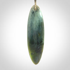 This picture shows a beautiful large sized drop pendant carved in New Zealand Tangiwai pounamu. It is a lovely chatoyant green/blue colour, which is semi-translucent when held to the light. A gorgeous and very meaningful pendant with an adjustable cord.