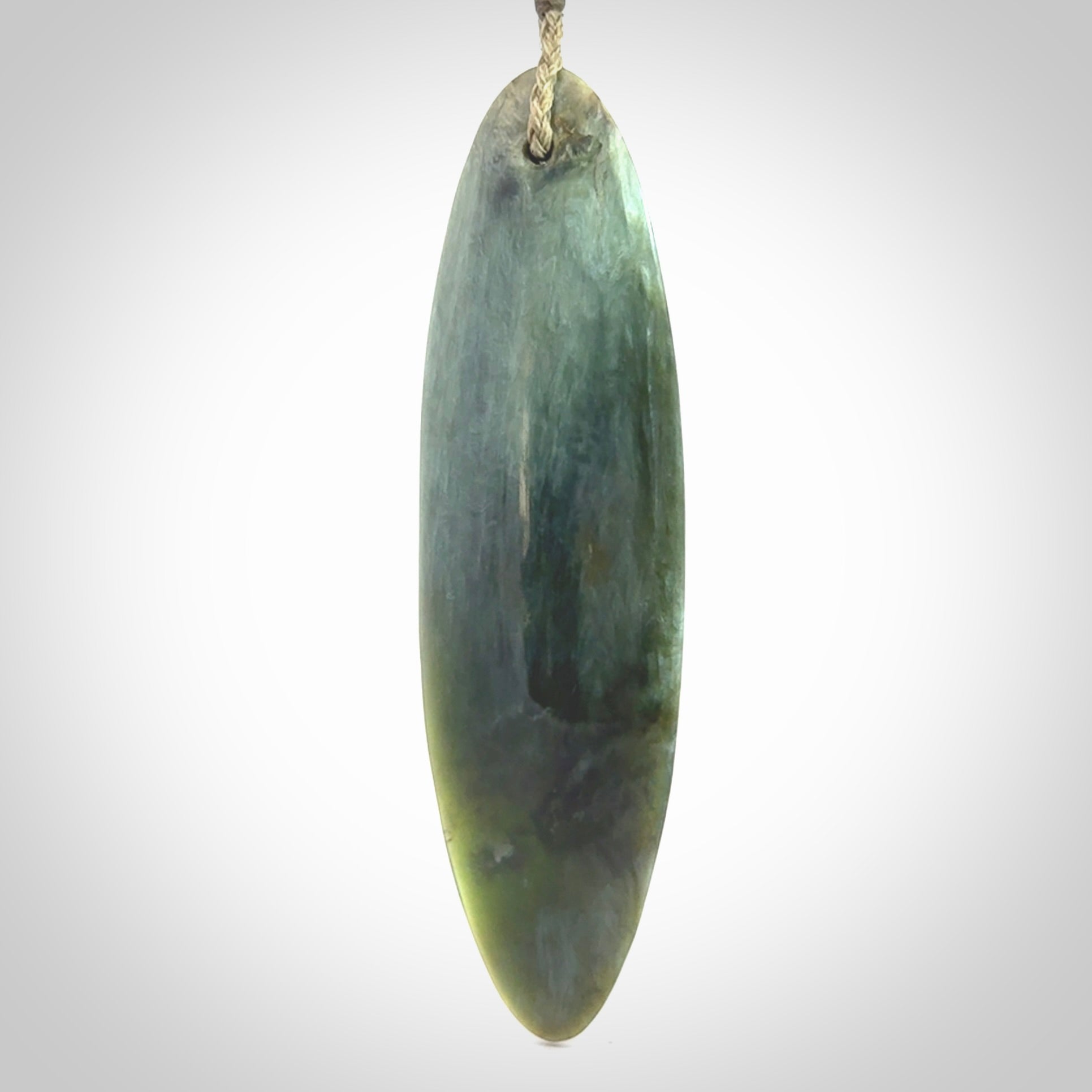 This picture shows a beautiful large sized drop pendant carved in New Zealand Tangiwai pounamu. It is a lovely chatoyant green/blue colour, which is semi-translucent when held to the light. A gorgeous and very meaningful pendant with an adjustable cord.