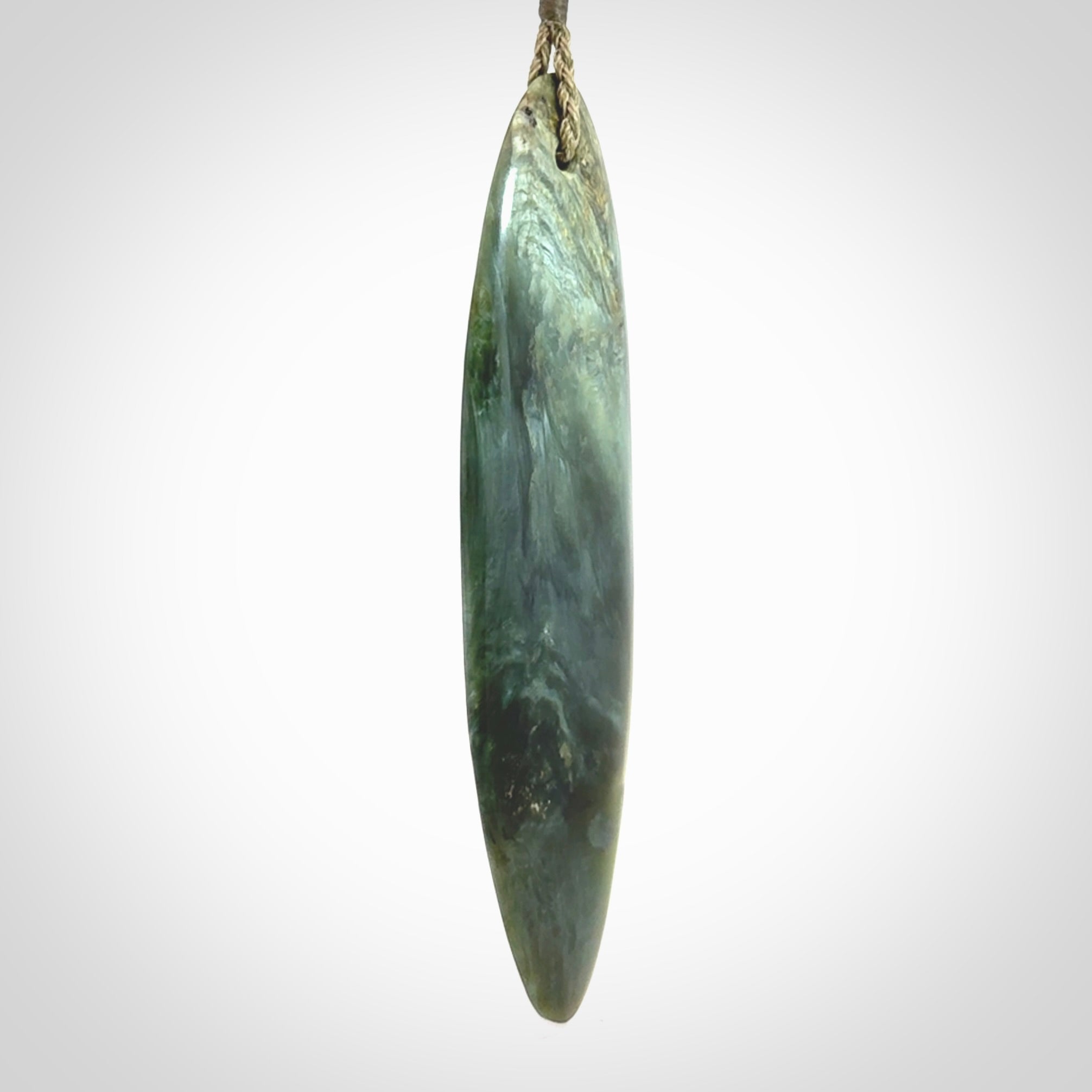 This picture shows a beautiful large sized drop pendant carved in New Zealand Tangiwai pounamu. It is a lovely chatoyant green/blue colour, which is semi-translucent when held to the light. A gorgeous and very meaningful pendant with an adjustable cord.