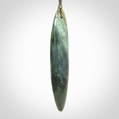 This picture shows a beautiful large sized drop pendant carved in New Zealand Tangiwai pounamu. It is a lovely chatoyant green/blue colour, which is semi-translucent when held to the light. A gorgeous and very meaningful pendant with an adjustable cord.