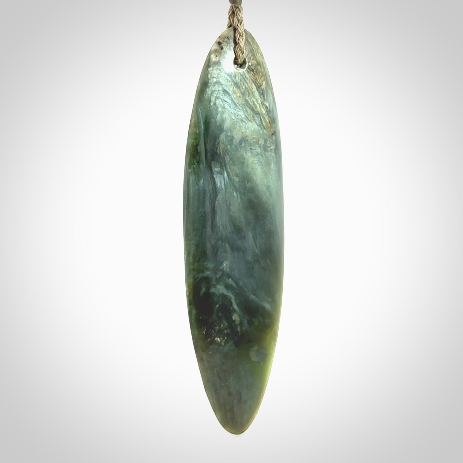 This picture shows a beautiful large sized drop pendant carved in New Zealand Tangiwai pounamu. It is a lovely chatoyant green/blue colour, which is semi-translucent when held to the light. A gorgeous and very meaningful pendant with an adjustable cord.