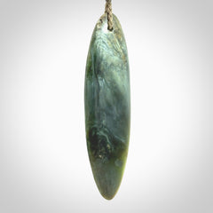 This picture shows a beautiful large sized drop pendant carved in New Zealand Tangiwai pounamu. It is a lovely chatoyant green/blue colour, which is semi-translucent when held to the light. A gorgeous and very meaningful pendant with an adjustable cord.