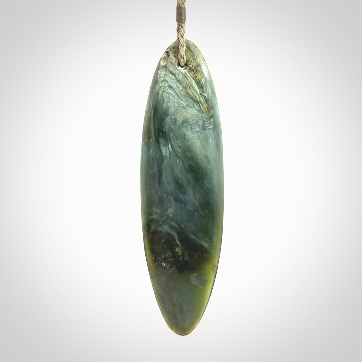 This picture shows a beautiful large sized drop pendant carved in New Zealand Tangiwai pounamu. It is a lovely chatoyant green/blue colour, which is semi-translucent when held to the light. A gorgeous and very meaningful pendant with an adjustable cord.