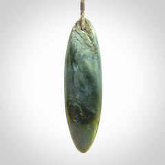 This picture shows a beautiful large sized drop pendant carved in New Zealand Tangiwai pounamu. It is a lovely chatoyant green/blue colour, which is semi-translucent when held to the light. A gorgeous and very meaningful pendant with an adjustable cord.