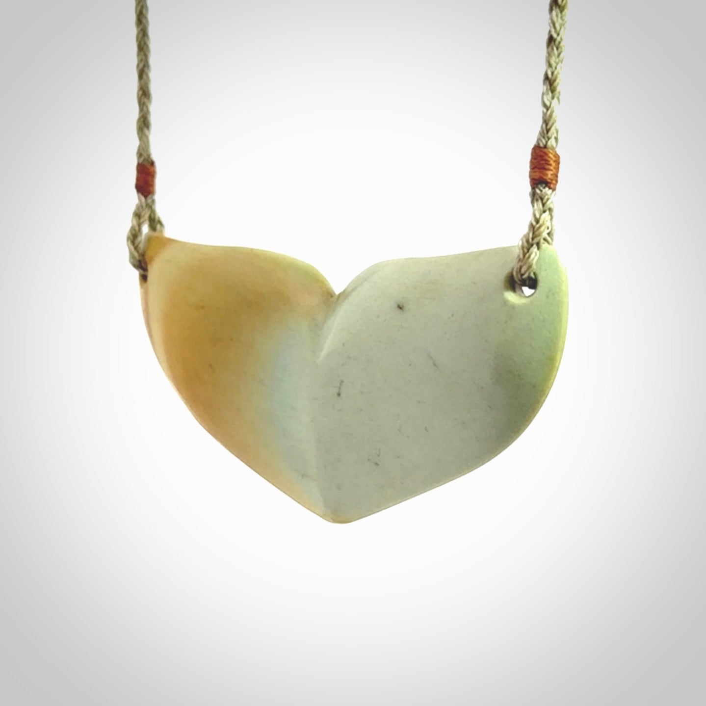 Hand carved New Zealand Flower Jade whale tail pendant.