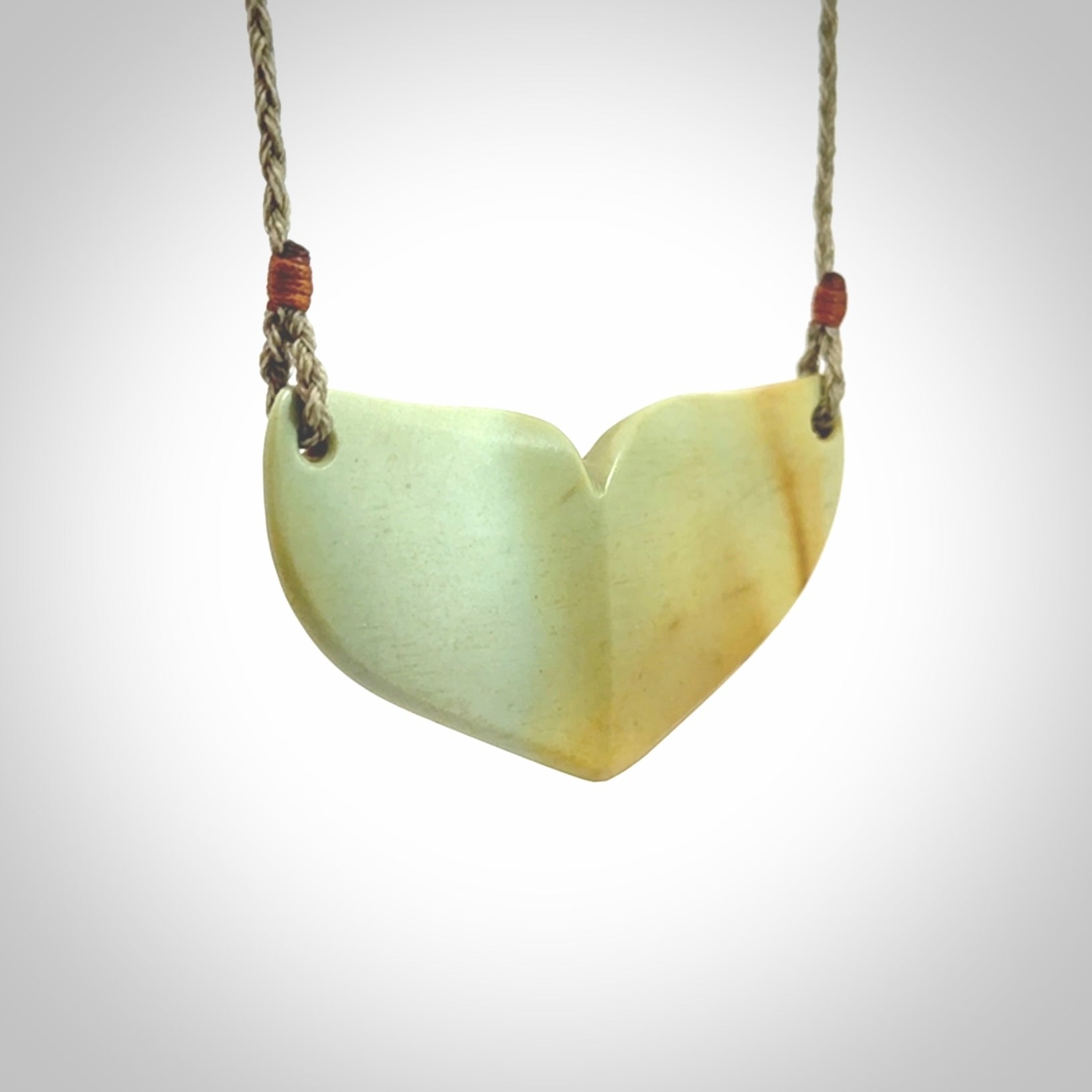 Hand carved New Zealand Flower Jade whale tail pendant.