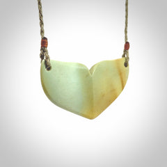 Hand carved New Zealand Flower Jade whale tail pendant.