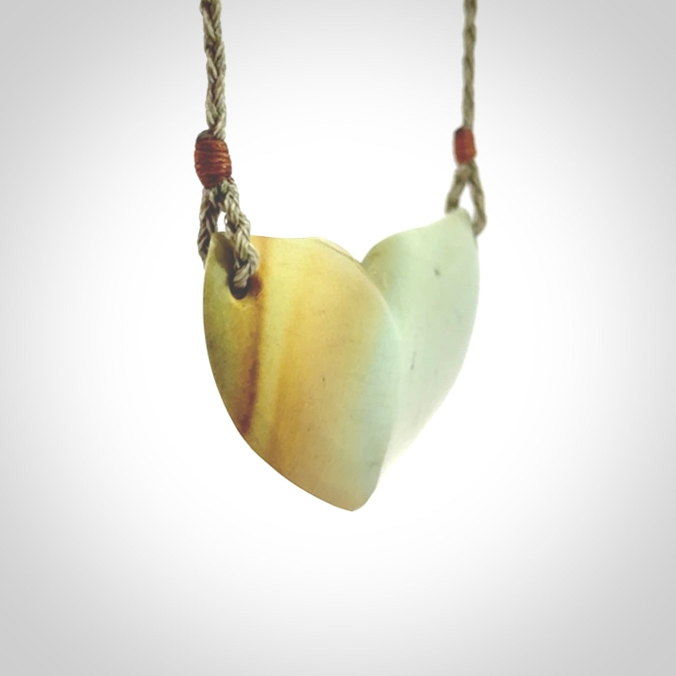 Hand carved New Zealand Flower Jade whale tail pendant.