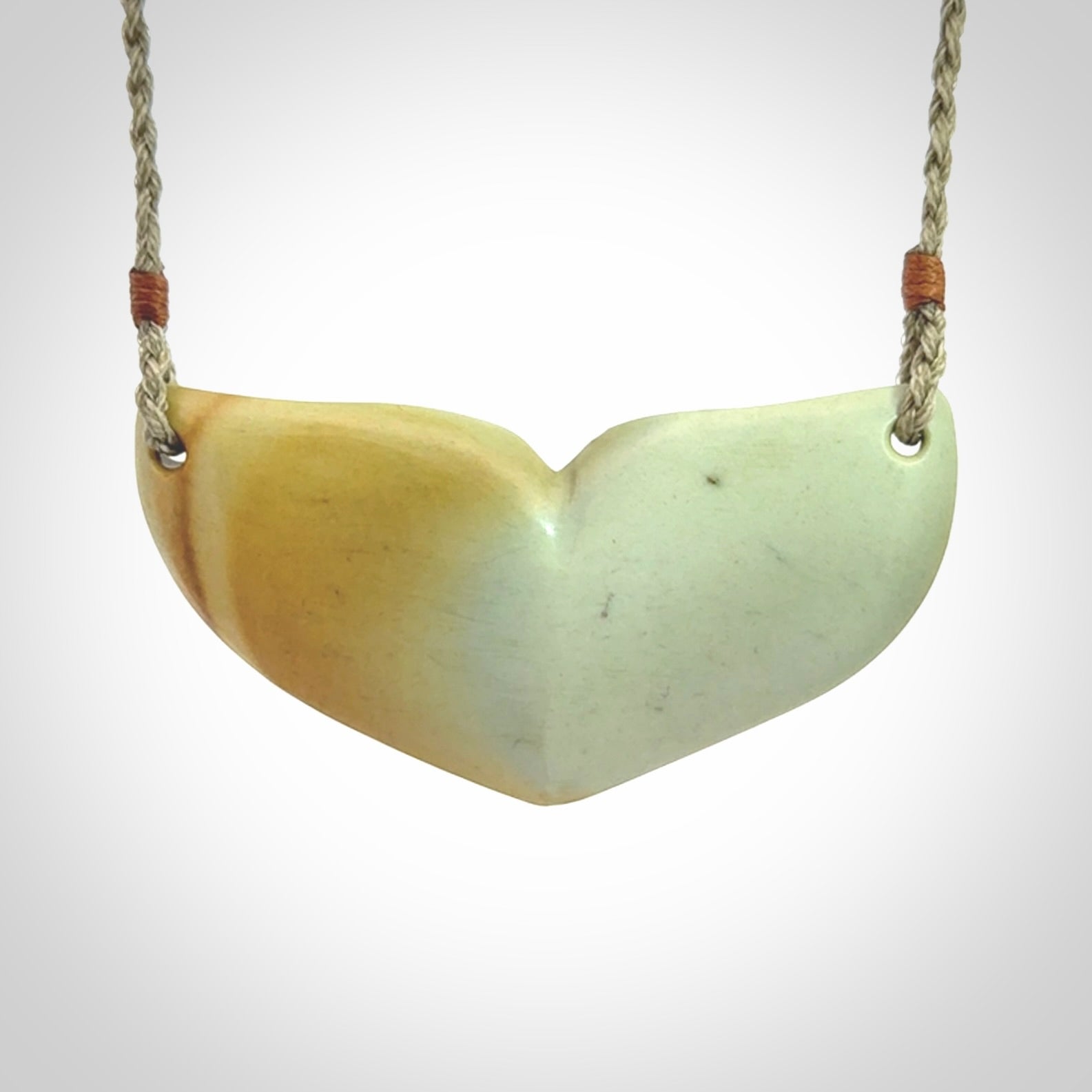 Hand carved New Zealand Flower Jade whale tail pendant.