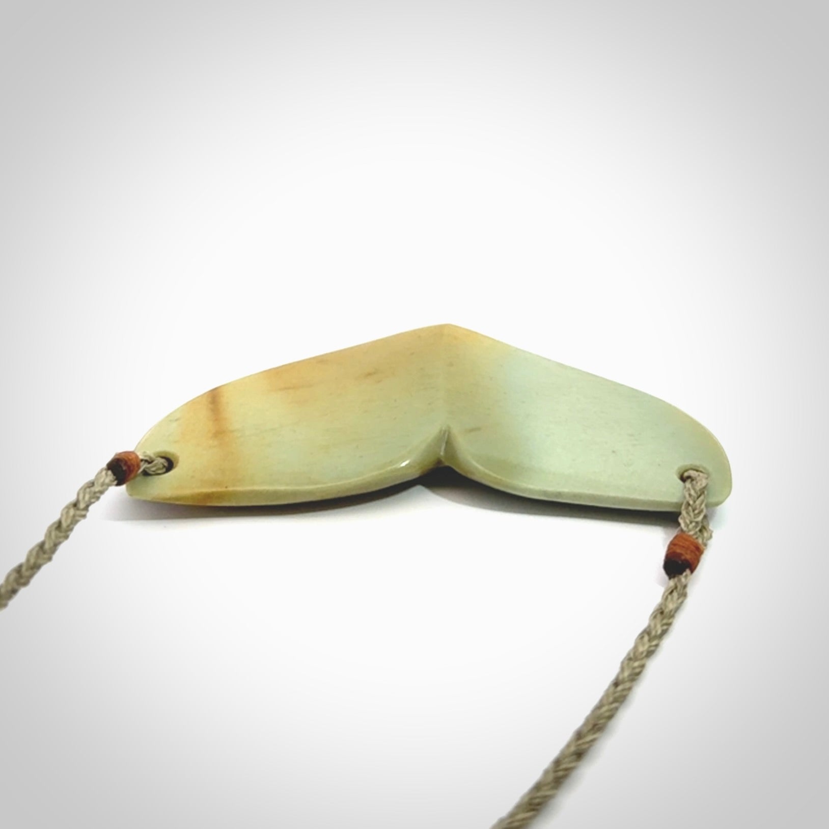 Hand carved New Zealand Flower Jade whale tail pendant.