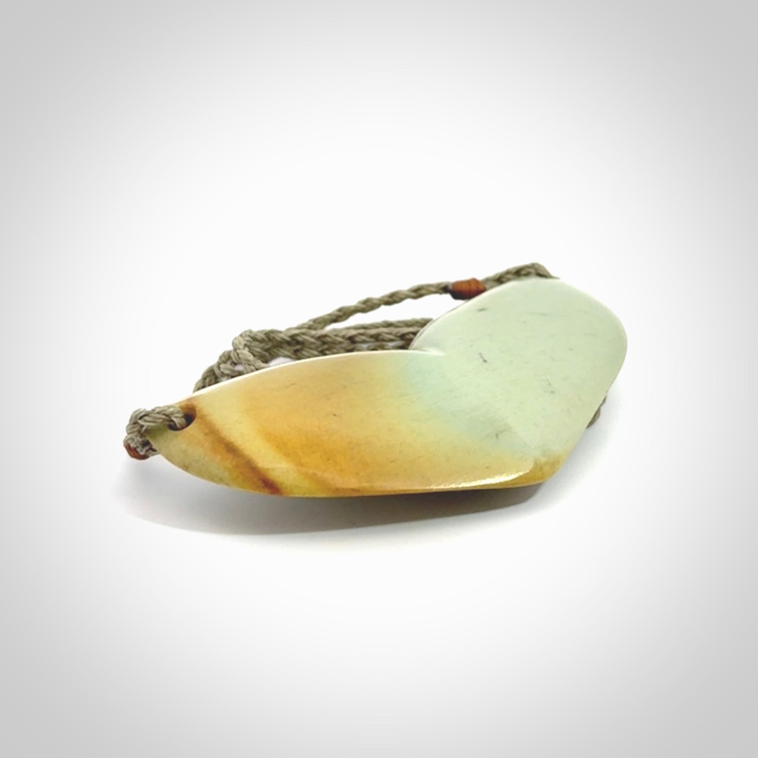 Hand carved New Zealand Flower Jade whale tail pendant.