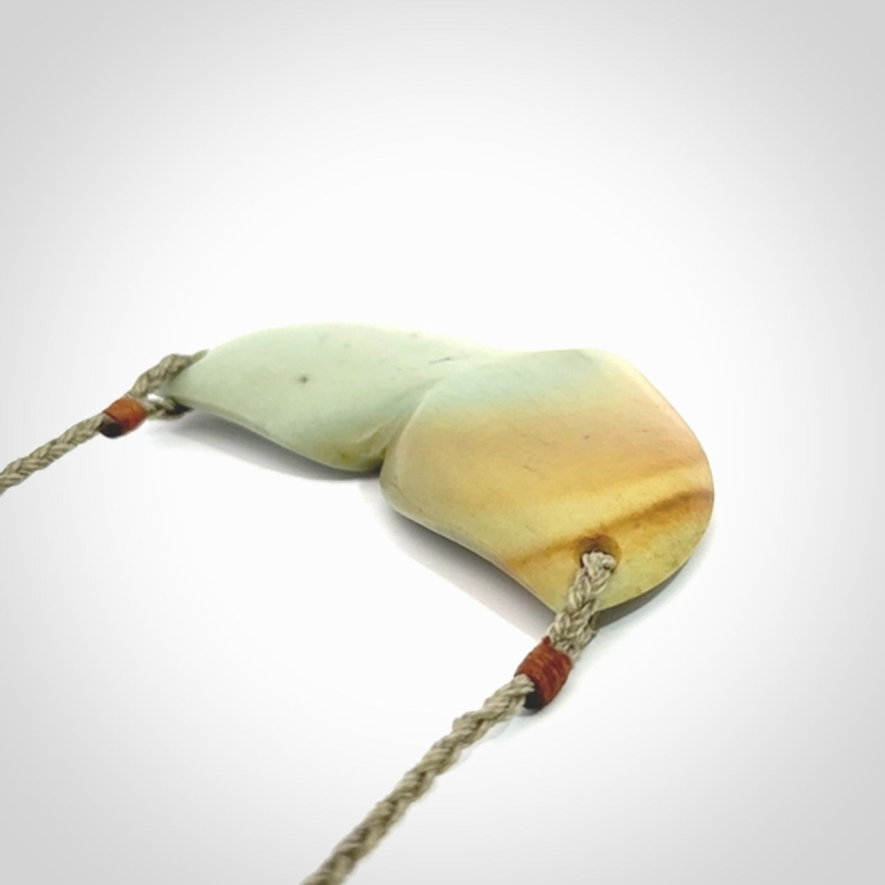 Hand carved New Zealand Flower Jade whale tail pendant.