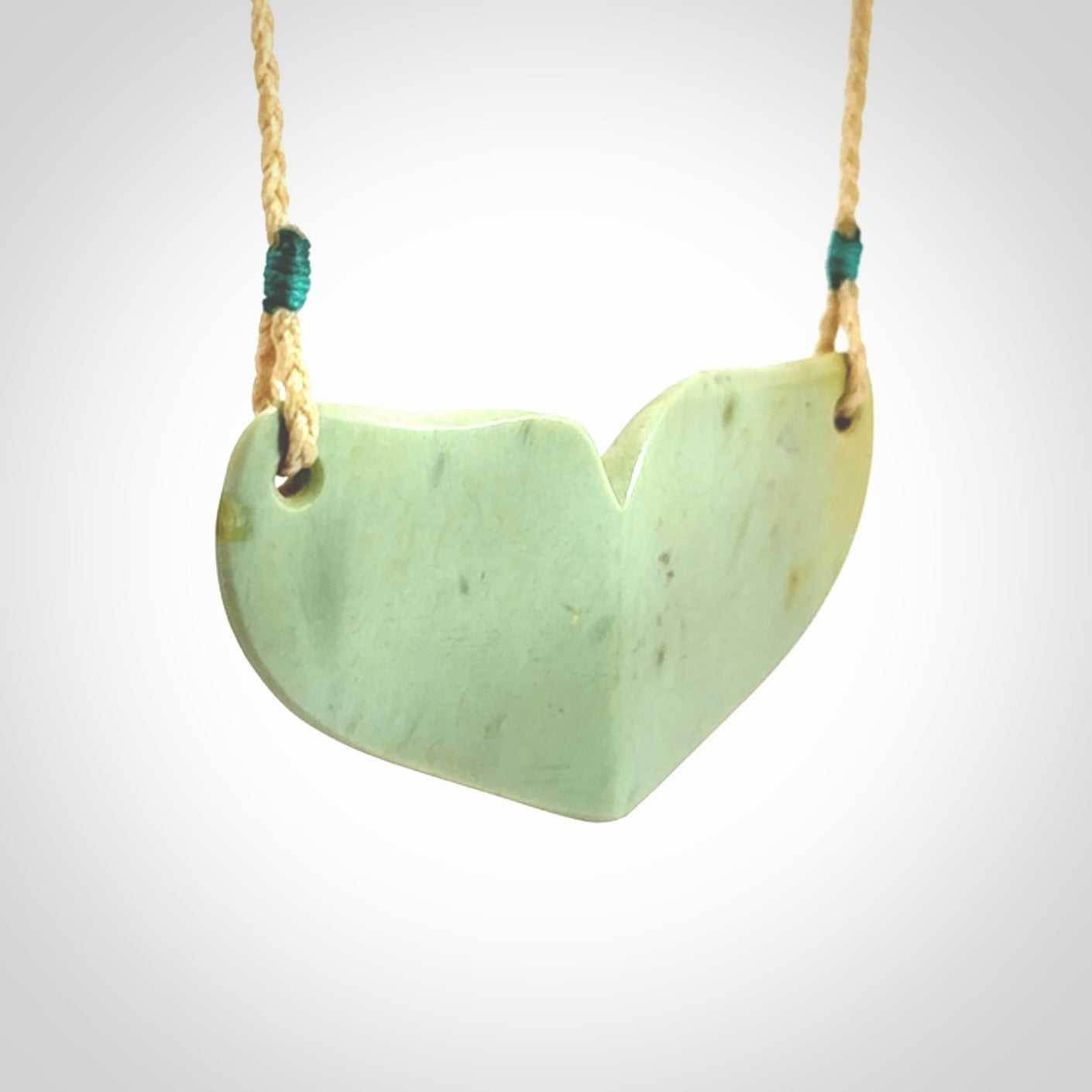 Hand carved New Zealand Flower Jade whale tail pendant.