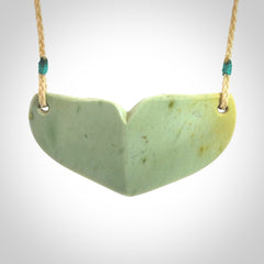 Hand carved New Zealand Flower Jade whale tail pendant.