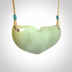 Hand carved New Zealand Flower Jade whale tail pendant.