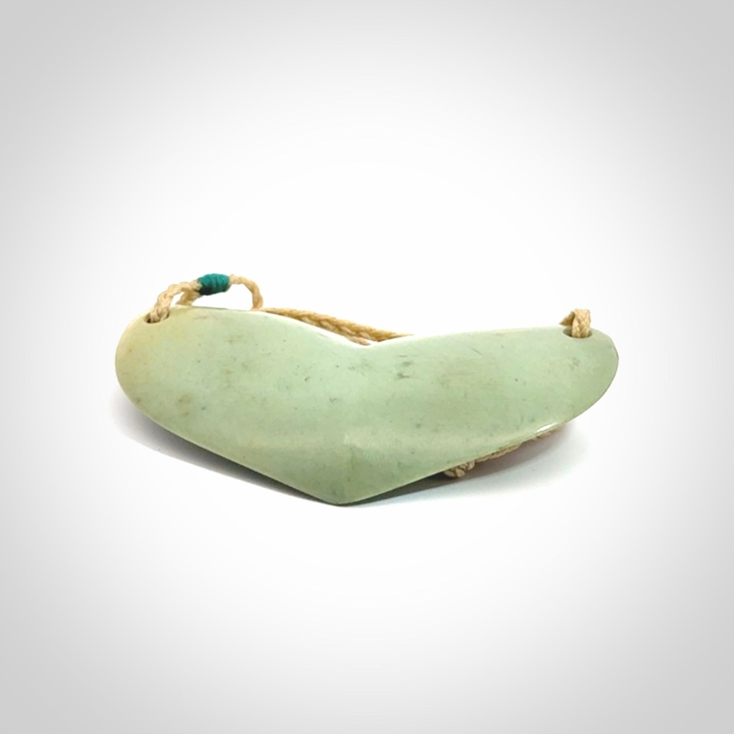 Hand carved New Zealand Flower Jade whale tail pendant.