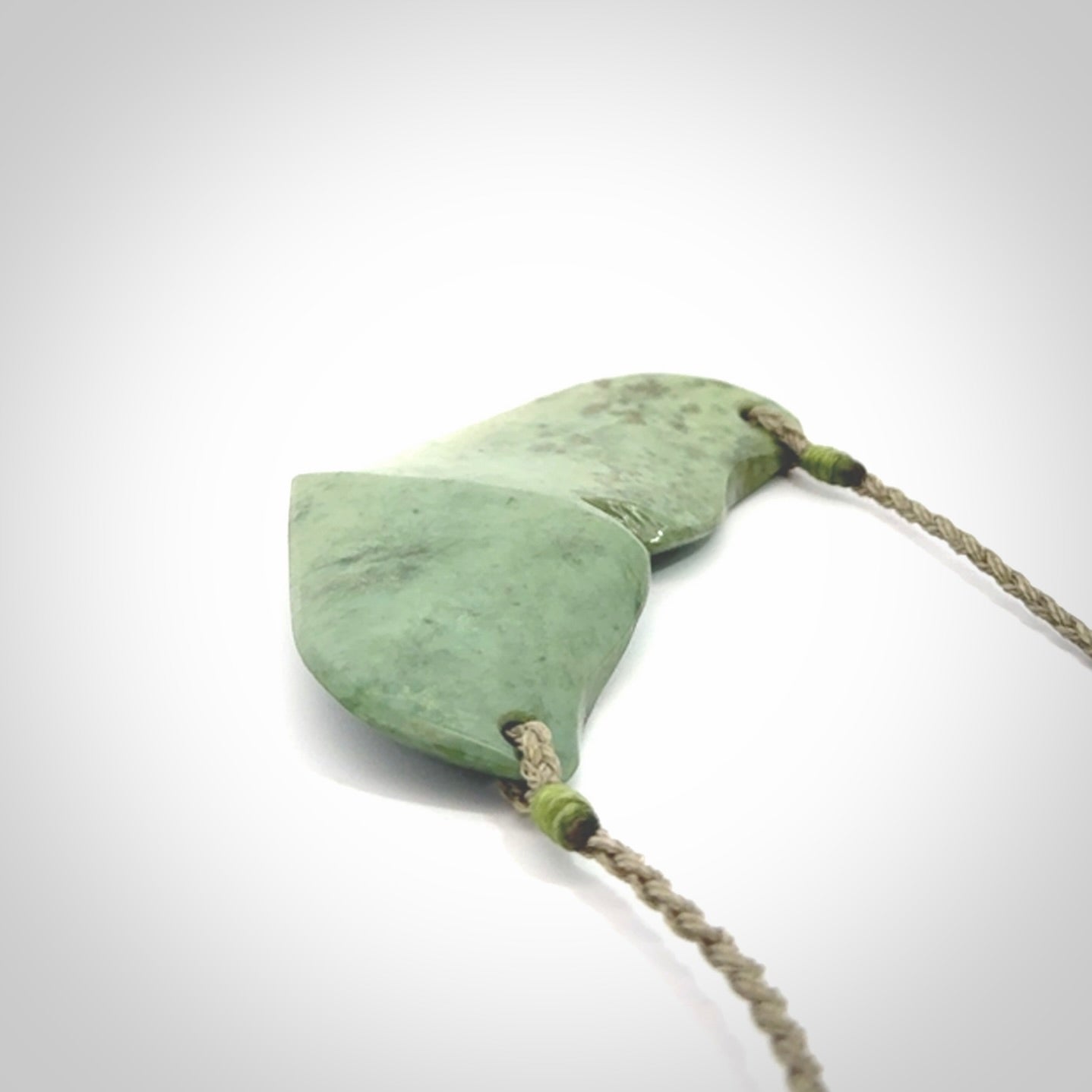Hand carved New Zealand Jade whale tail pendant.