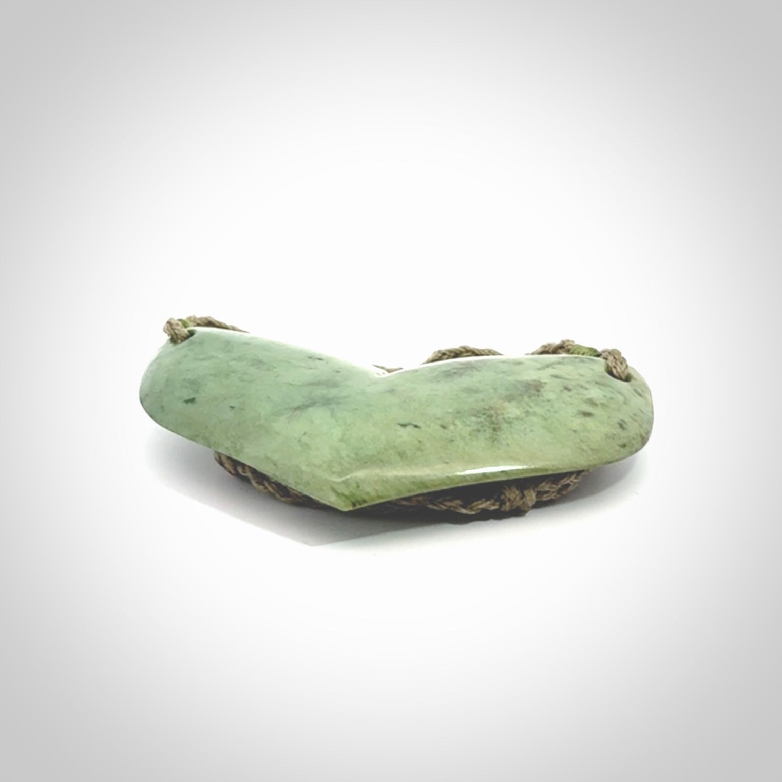 Hand carved New Zealand Jade whale tail pendant.