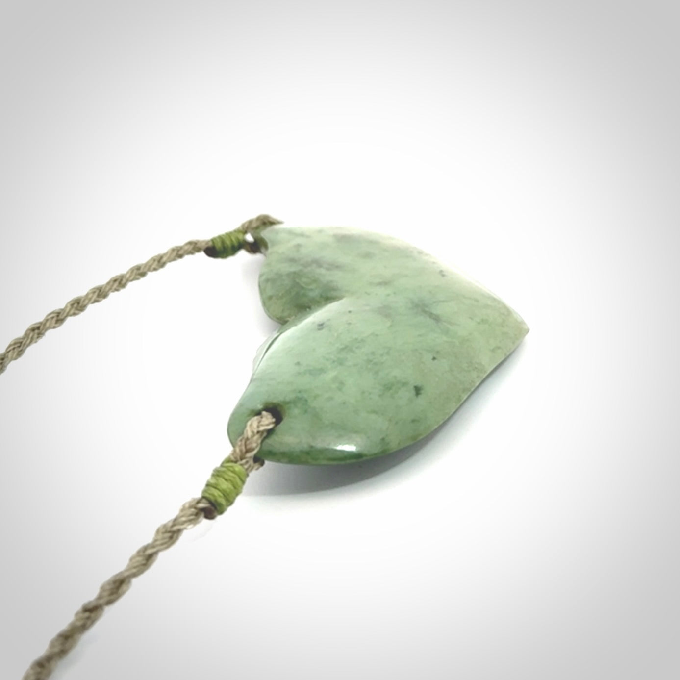 Hand carved New Zealand Jade whale tail pendant.