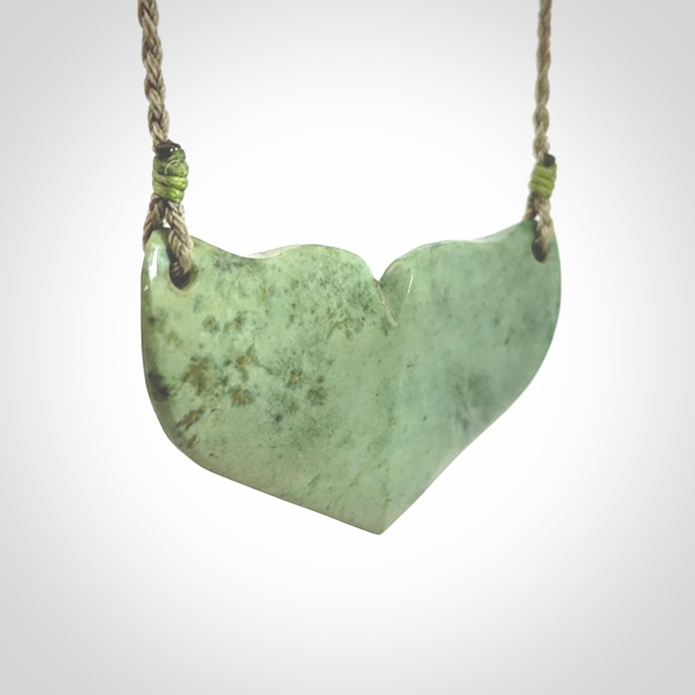 Hand carved New Zealand Jade whale tail pendant.